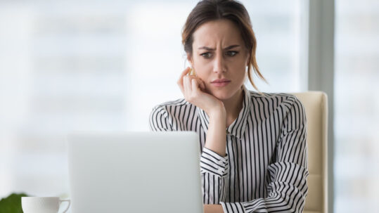 A frustrated user looking at a computer screen